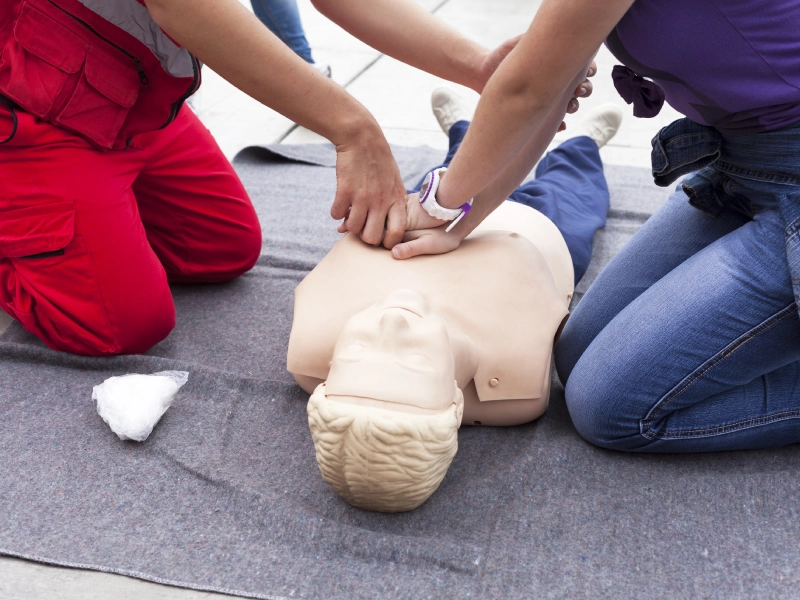 CPR training: two people practicing chest compressions.